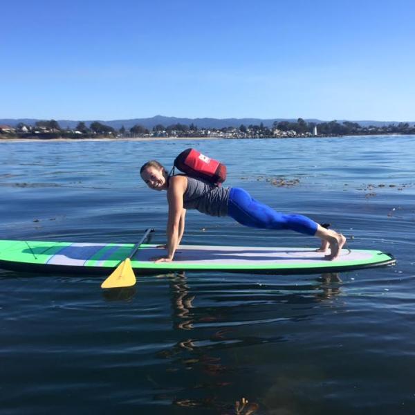 girl doing pushup on paddleboard