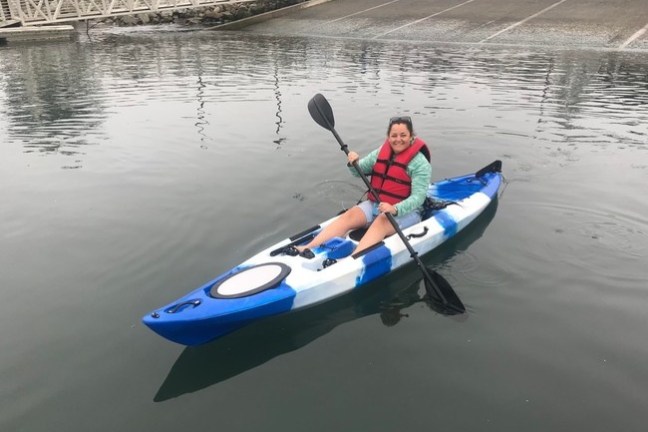 a person riding on the back of a boat in a body of water