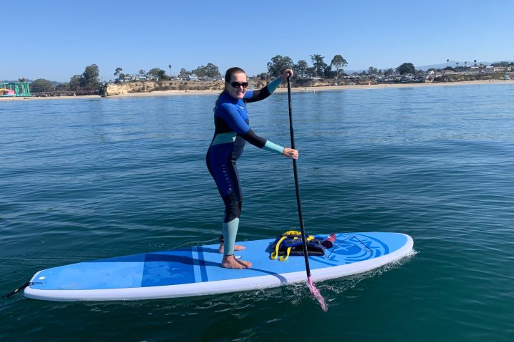 a person riding a surf board on a body of water