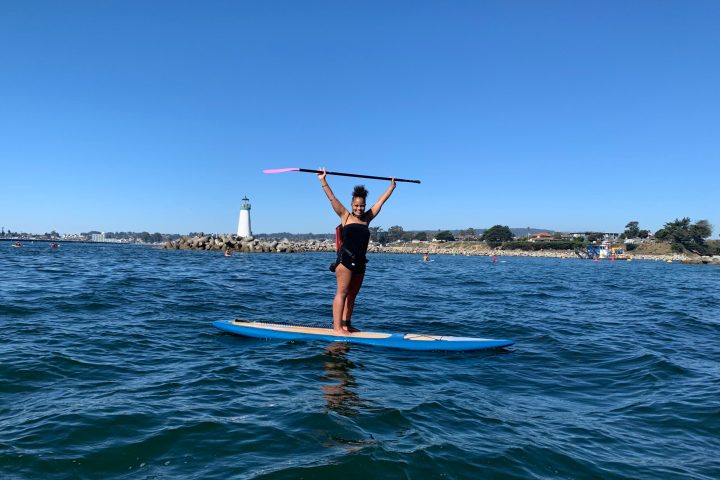 a person riding a surf board on a body of water
