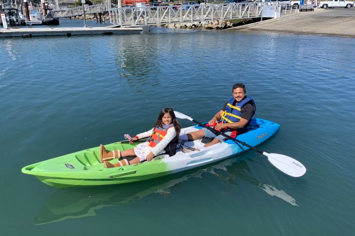 a group of people in a small boat in a body of water